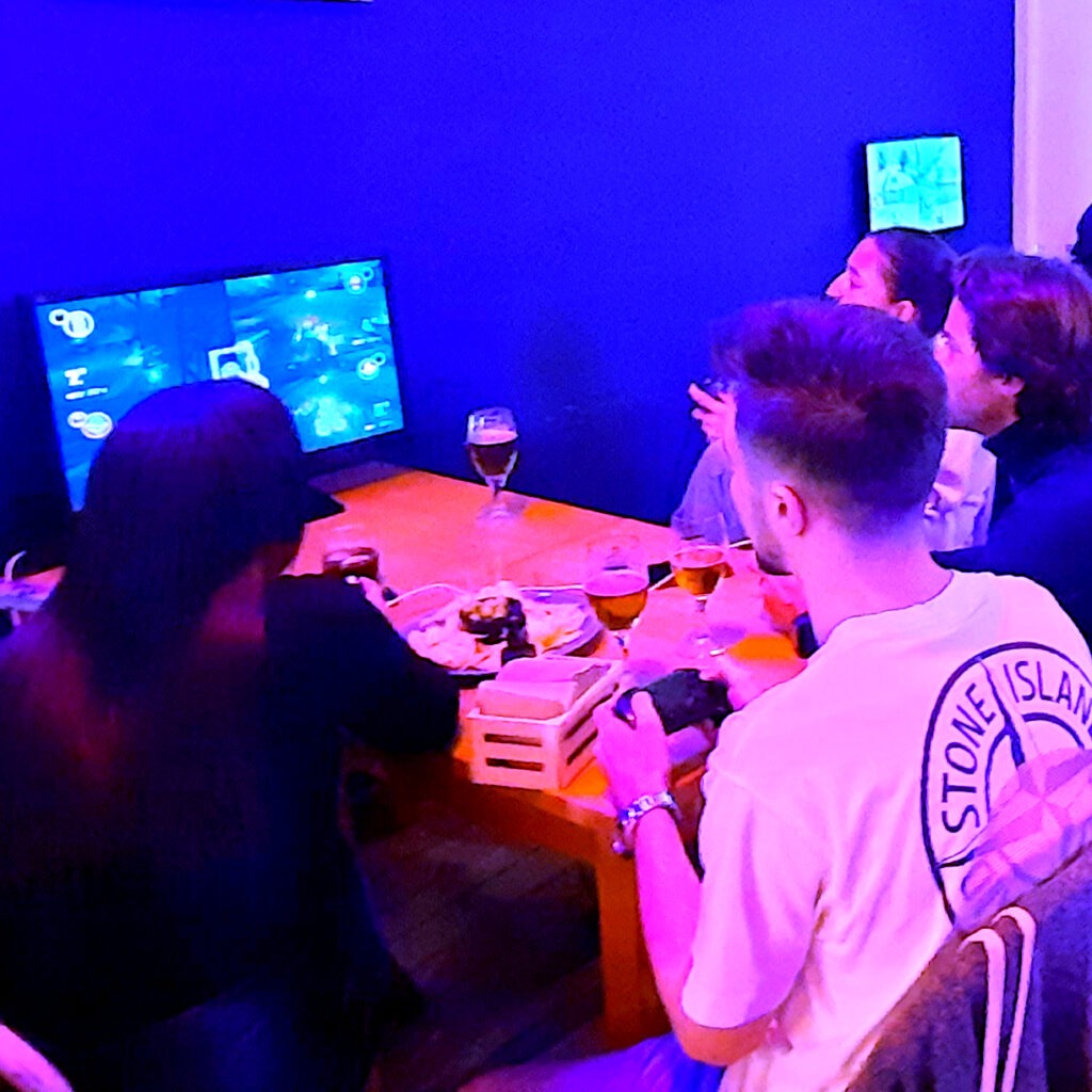 a group enjoys an indoor MarioKart tournament